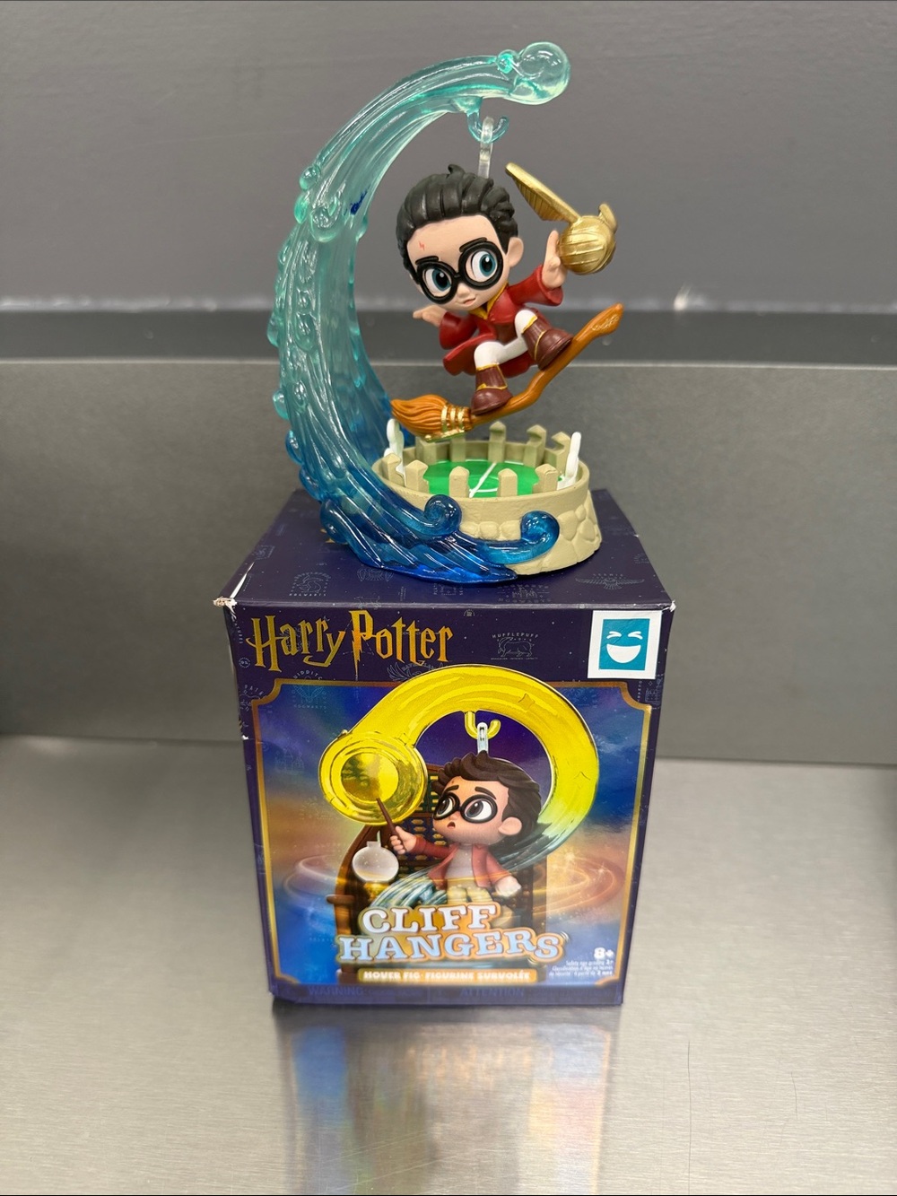 Warner Bros. Harry Potter Figure with Red Outfit and Teal Wave Effect